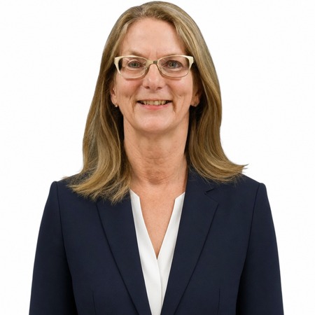 Anna Haranas | Career Calling International A professional woman named Anna Haranas smiles while wearing a dark suit, representing our vet compliance expertise.